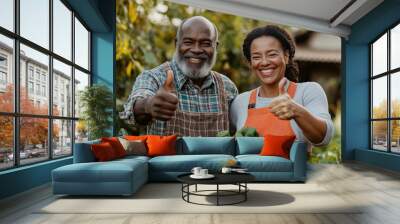 A couple of middle-aged black people giving thumb up near the harvest from their autumn garden.  Gardening peoples. Wall mural