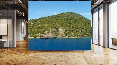 two boats moored at green island with ancient ruins Wall mural