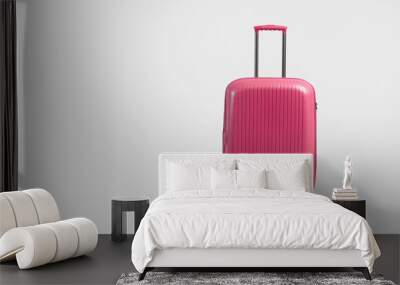 Pink trolley suitcase isolated on white Wall mural