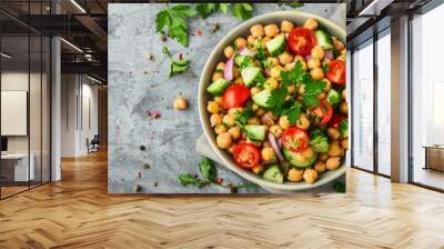 Healthy and tasty vegan food. Chickpea salad with parsley, cherry tomatoes, onion, cucumber and green olives on grey concrete background  Wall mural