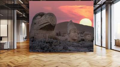 View of mount Nemrut and monumental sculptures of commagene kings and gods with colorful clouds and sun at sky Wall mural