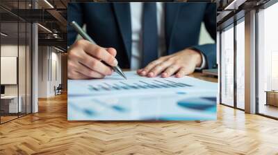 Businessman analyzing financial balance sheet and corporate profit report graph at office Wall mural