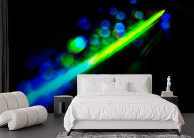 Abstract colorful spectrum in darkness. Colorful rays of light. Wall mural