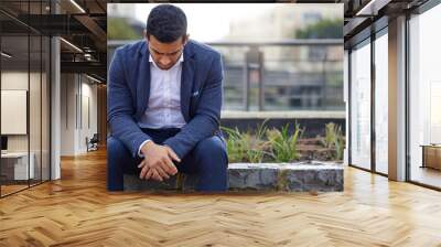 Life can make any man weary. Shot of a young businessman looking upset. Wall mural