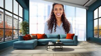 Personal success leads to business success. Cropped portrait of an attractive young businesswoman standing with her arms folded in the office. Wall mural