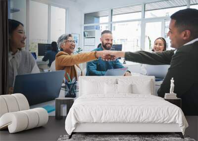 Creative people, handshake and meeting in hiring, partnership or deal agreement together at the office. Group of employees shaking hands in recruiting, company growth or startup at the workplace Wall mural