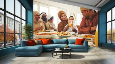 Food, love and muslim with big family at table for eid mubarak, Islamic celebration and lunch. Ramadan festival, culture and iftar with people eating at home for fasting, islam and religion holiday Wall mural