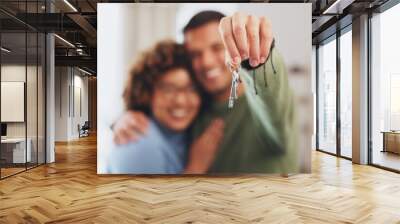 Hand, keys and a home owner couple proud of their real estate property investment or purchase. House, mortgage or beginning with a blurred background man and woman together in their new apartment Wall mural