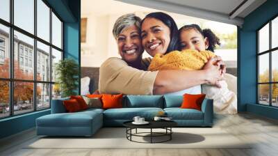 Hug, portrait and a grandmother, child and mother with happiness, love and care on mothers day. Happy, house and a senior woman, mom and girl with embrace as family for support together on the sofa Wall mural