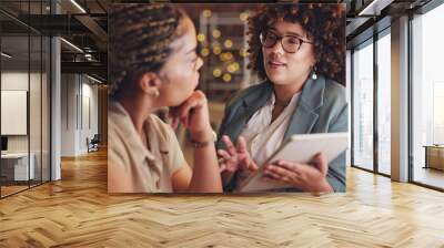 Tablet, meeting and collaboration with a business woman team in the office at night for strategy or planning. Teamwork, talking or discussion with a female employee and partner at work together Wall mural