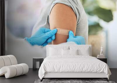 Covid virus vaccination, vaccine and doctor hands with plaster on patient arm in a medical hospital or clinic. Healthcare worker help, trust and safety flu shot antigen for protection against disease Wall mural