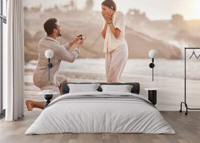 Will you do life with me forever. a young man proposing to his girlfriend on the beach. Wall mural