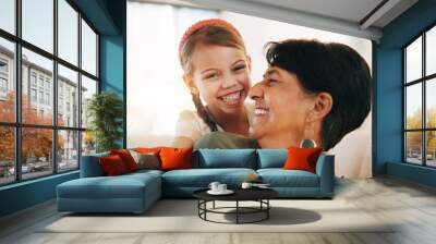 Child, grandmother and hug on sofa for laugh bonding, relax connection in retirement. Girl, old woman and embrace on couch for holiday rest or together in lounge for funny joke, love support or care Wall mural