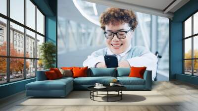 Phone, smile and a woman with a disability in an airport for travel or online booking confirmation. Business, communication and a flight passenger in a wheelchair for check in or accessibility Wall mural