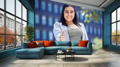 Business, woman and portrait in city with thumbs up for commercial property achievement and lease agreement. Real estate agent, employee and yes gesture for building purchase success or mortgage sale Wall mural