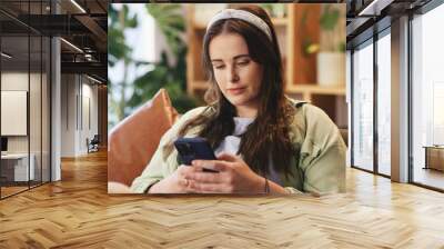 Sofa, woman and online with smartphone for chat, connection and message with contact. Home, female person and text with mobile app for communication, dating website and profile update for match Wall mural