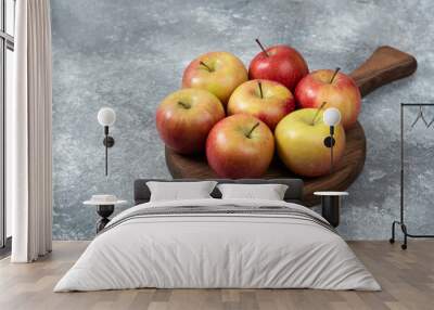 Bunch of fresh ripe apples placed on wooden board Wall mural