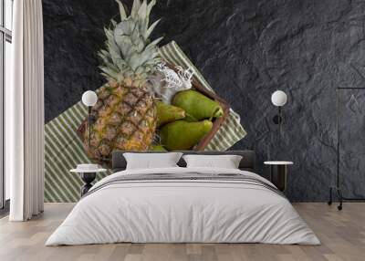 Juicy ripe pineapple and fresh pears in wooden box Wall mural