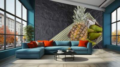 Juicy ripe pineapple and fresh pears in wooden box Wall mural