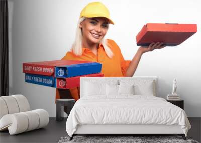 Pizza delivery woman holding pizza on white background while smiling Wall mural