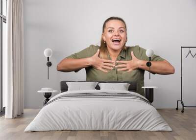 Portrait of woman holding her chest because of feeling happy Wall mural