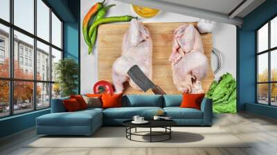 Raw half cut chicken with lettuce, peppers and tomato on wooden board Wall mural