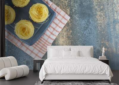 Six stacks of thin spaghettis in the board ,on towel, on the marble background Wall mural