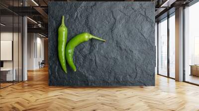 Top view of fresh hot peppers on black background. Horizontal photo Wall mural