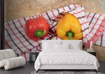 Two colorful peppers lying on tablecloth Wall mural