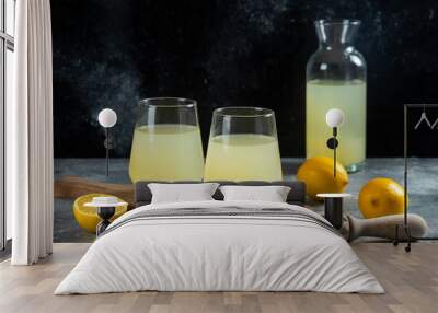 Two cups of lemon juice on a wooden board Wall mural