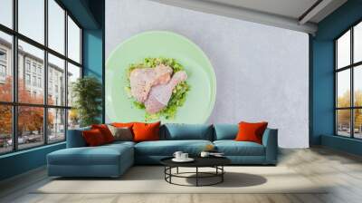 Two marinated chicken legs in the plate, on the white background Wall mural