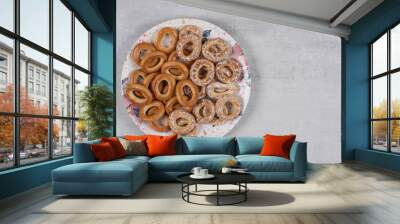 Two types of tasty pretzel rings on white plate Wall mural