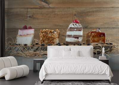 Variety of sweet cakes on wood piece Wall mural