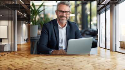 Cheerful Businessman Working with Laptop in Office Wall mural