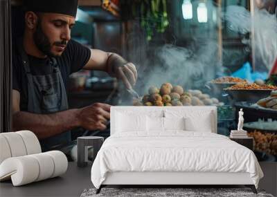 A vendor in Cairo, frying and serving falafel balls in pita bread, with a variety of toppings. Wall mural