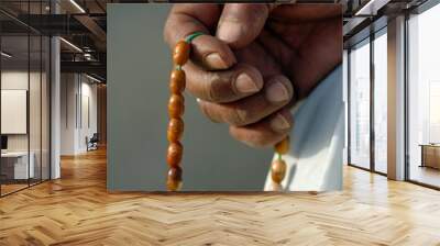 hand holding a misbaha rosary for religious reading, dhikr and remembrance
 Wall mural