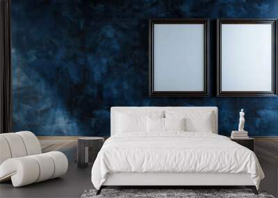 A deep sapphire wall featuring two rectangular empty blank picture frames, one larger than the other, arranged side by side with a polished wooden floor beneath. Wall mural