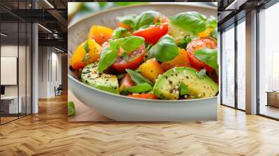 A bowl of salad with tomatoes, avocado, and basil Wall mural