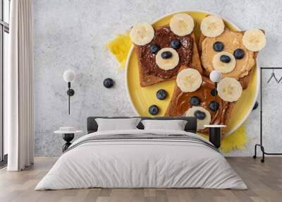 Breakfast toasts with nut butter, banana and blueberry with cute funny animal face. Kids food, breakfast for kids or school lunch. Top view Wall mural