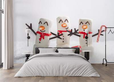 Happy funny marshmallow snowman are having fun in snow. Merry Christmas card. Christmas concept Wall mural