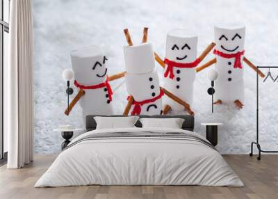 Happy funny marshmallow snowmans on snow Wall mural