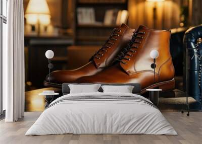 A pair of brown leather boots with laces on a dark leather surface. Wall mural