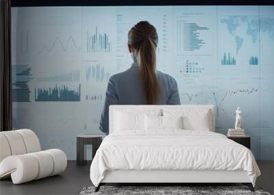 A professional analyzing data on a digital display in a modern office environment. Wall mural