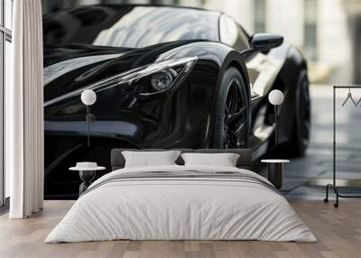 Close-up of a black sports car with a sleek design and modern headlights parked on a paved surface. Wall mural