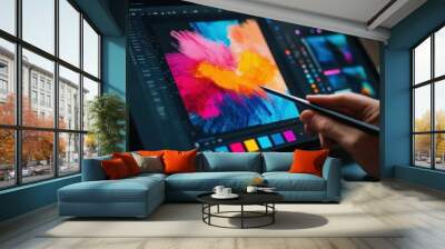 Closeup of a hand using a stylus to edit a colorful abstract image on a tablet. Wall mural