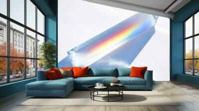 Glass prism casting a rainbow on a white background. Wall mural