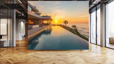 Modern house with infinity pool overlooking ocean at sunset. Wall mural