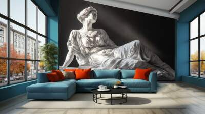 Reclining female statue on a marble base with a spotlight. Wall mural