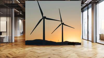 Wind turbines, green energy windmills silhouetted against golden sunset sky, Northern California wine country.  Wall mural