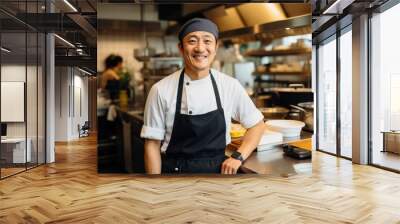 Middle aged asian chef working in a restaurant kitchen smiling portrait Wall mural